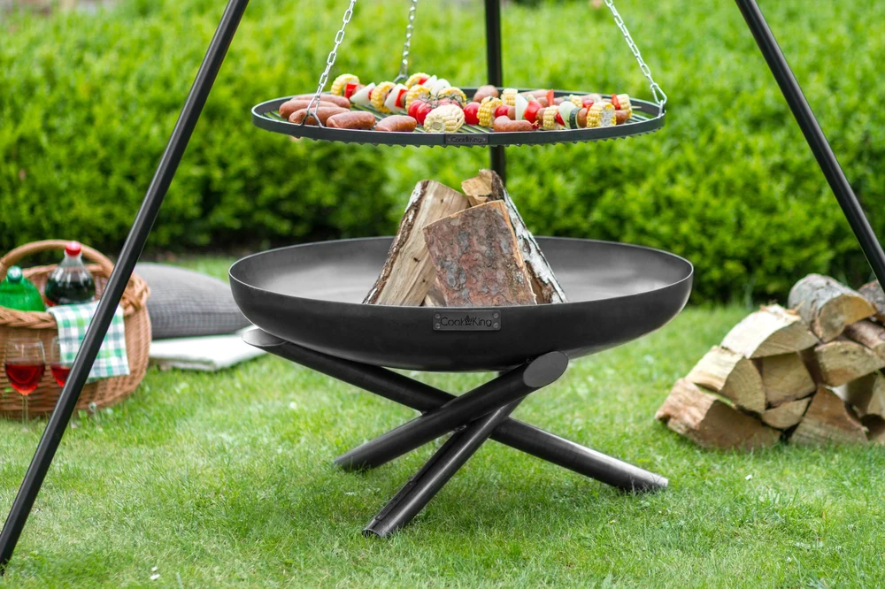 COOK KING tripod grill cooking in a meadow